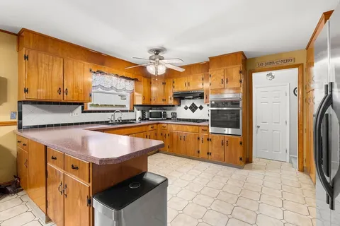 a kitchen with stainless steel appliances granite countertop a stove a sink and a refrigerator