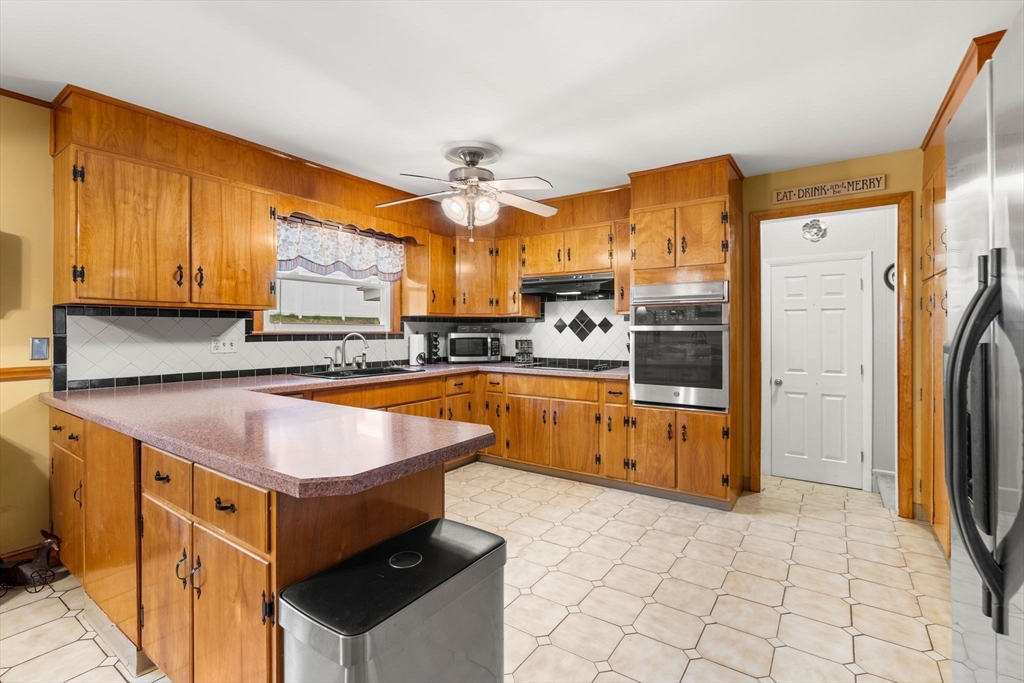 8 Agnes Terrace Methuen, MA 01844 - Photo 10 of 41 a kitchen with stainless steel appliances granite countertop a stove a sink and a refrigerator