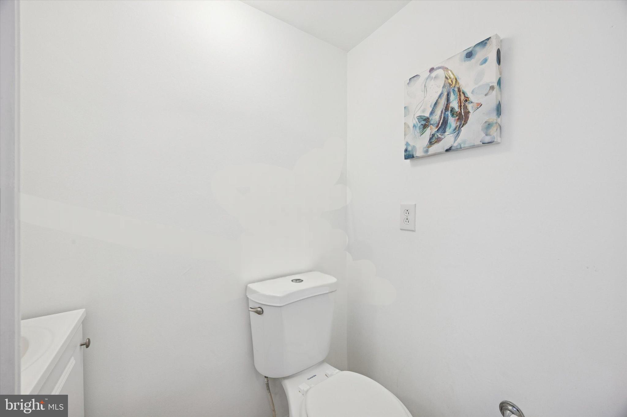 7033 Sherwood Road Philadelphia, PA 19151 - Photo 13 of 16 a white toilet sitting next to a white wall