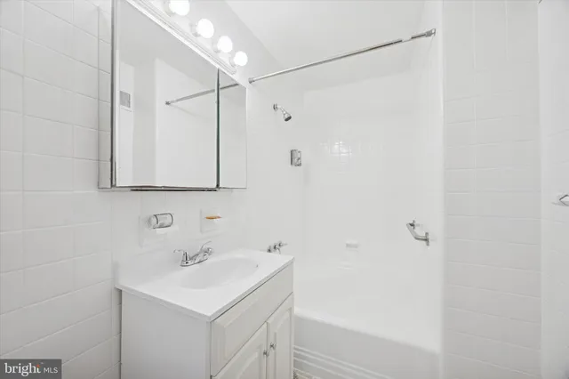 a bathroom with a sink a shower and a mirror