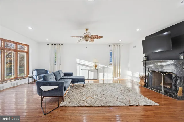 a living room with furniture a fireplace and a flat screen tv