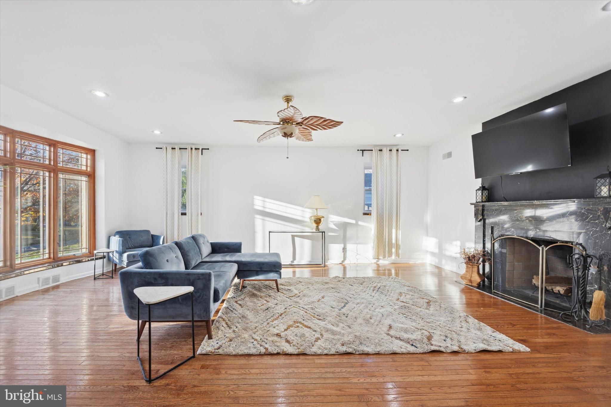 7033 Sherwood Road Philadelphia, PA 19151 - Photo 4 of 16 a living room with furniture a fireplace and a flat screen tv