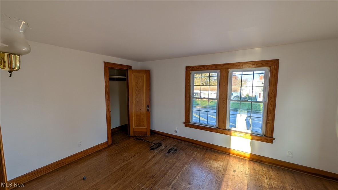 2511 Milan Road Sandusky, OH 44870 - Photo 26 of 40 Unfurnished bedroom with a closet and dark hardwood / wood-style floors