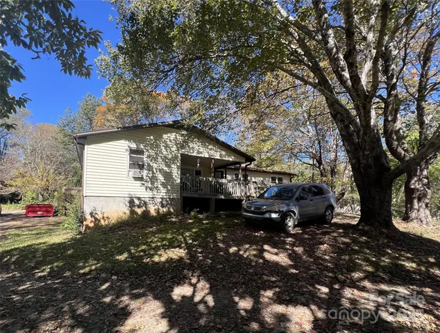 a view of house with backyard