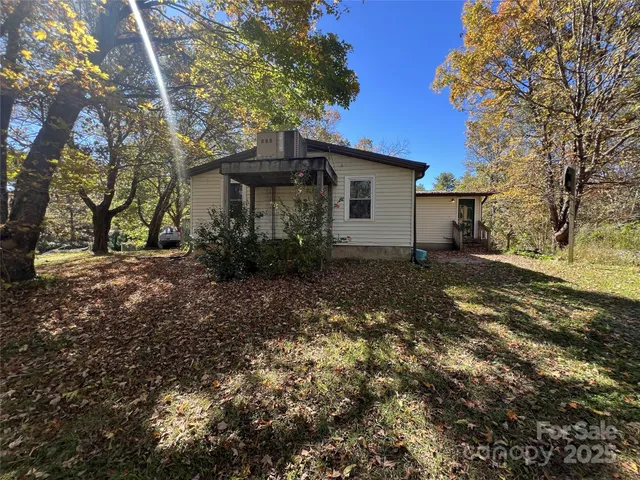 a view of a house with a tree in the yard