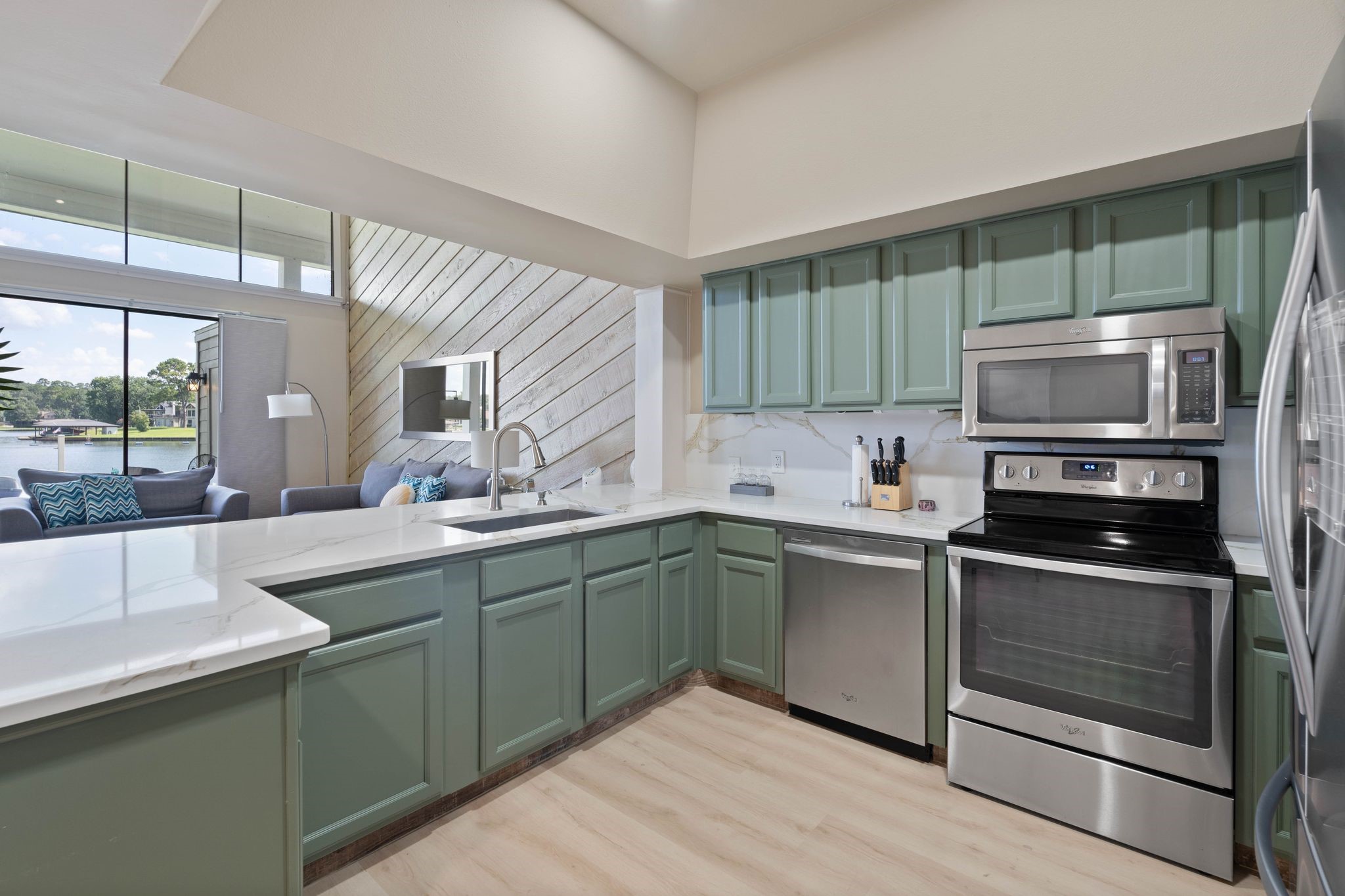 68 April Point Drive South, Unit E68 Conroe, TX 77356 - Photo 14 of 46 a kitchen with sink a microwave and cabinets
