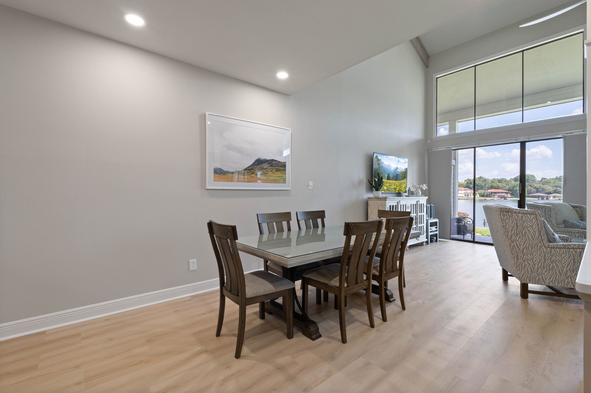 68 April Point Drive South, Unit E68 Conroe, TX 77356 - Photo 16 of 46 a view of a dining room with furniture wooden floor and a potted plant