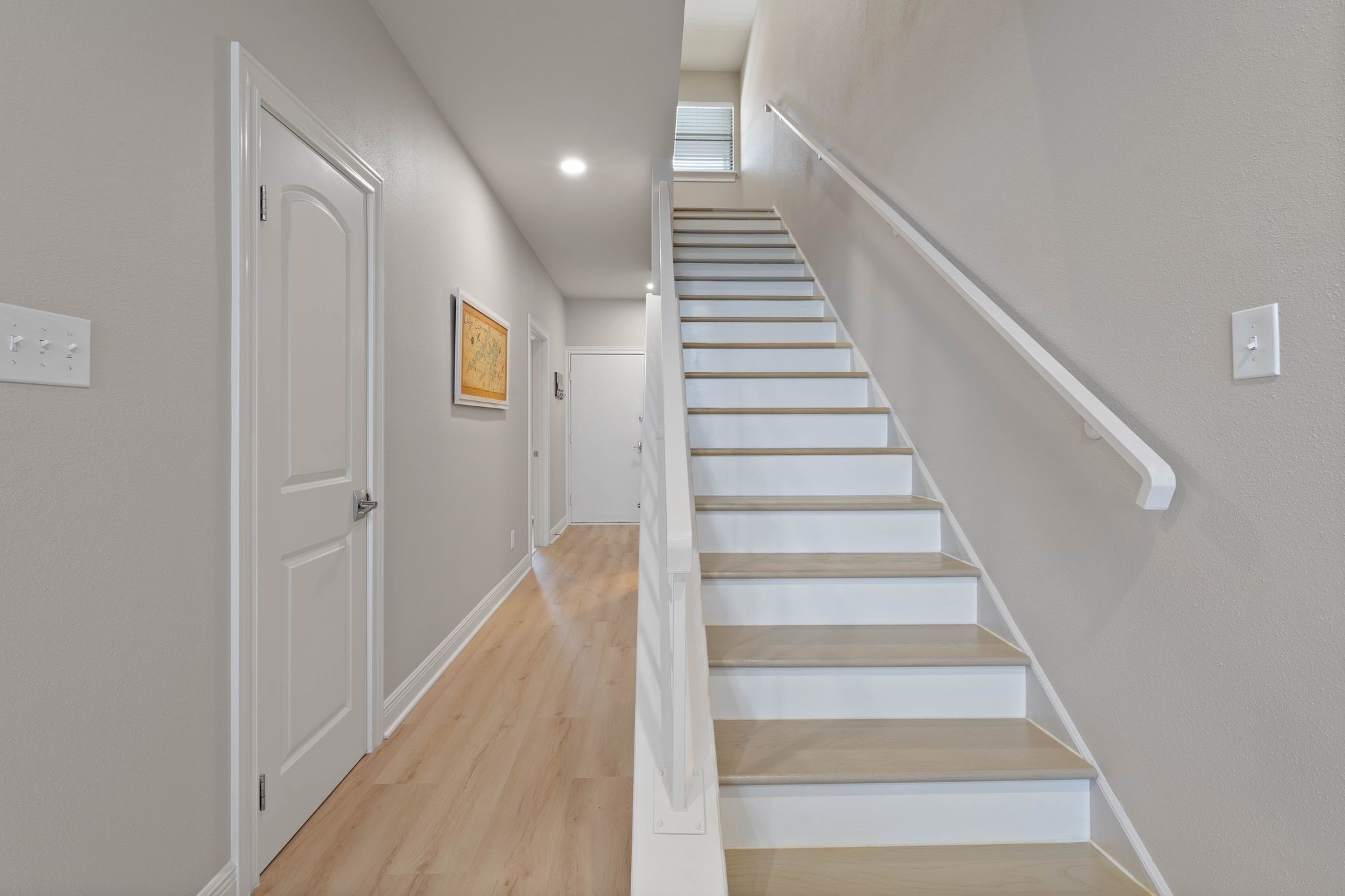 68 April Point Drive South, Unit E68 Conroe, TX 77356 - Photo 23 of 46 a view of staircase with wooden floor and white walls