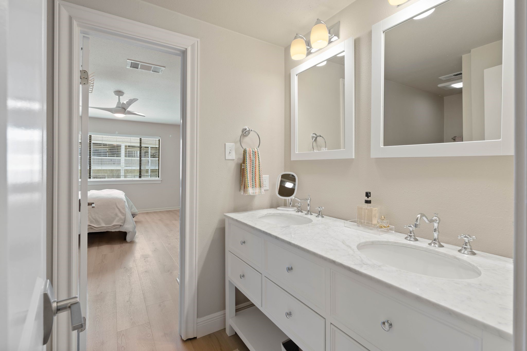 68 April Point Drive South, Unit E68 Conroe, TX 77356 - Photo 28 of 46 a en suite bathroom with a sink double vanity and a mirror