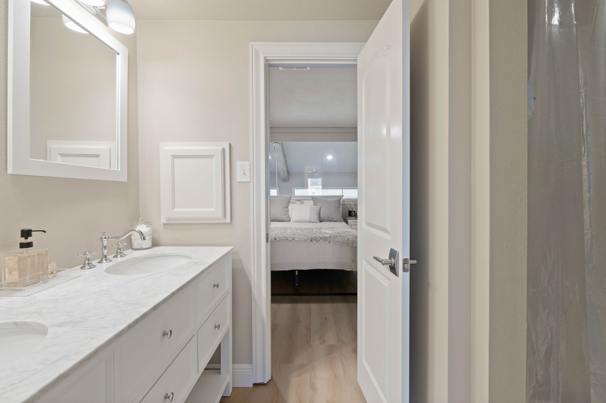 68 April Point Drive South, Unit E68 Conroe, TX 77356 - Photo 29 of 46 a en suite bathroom with a double vanity sink and mirror