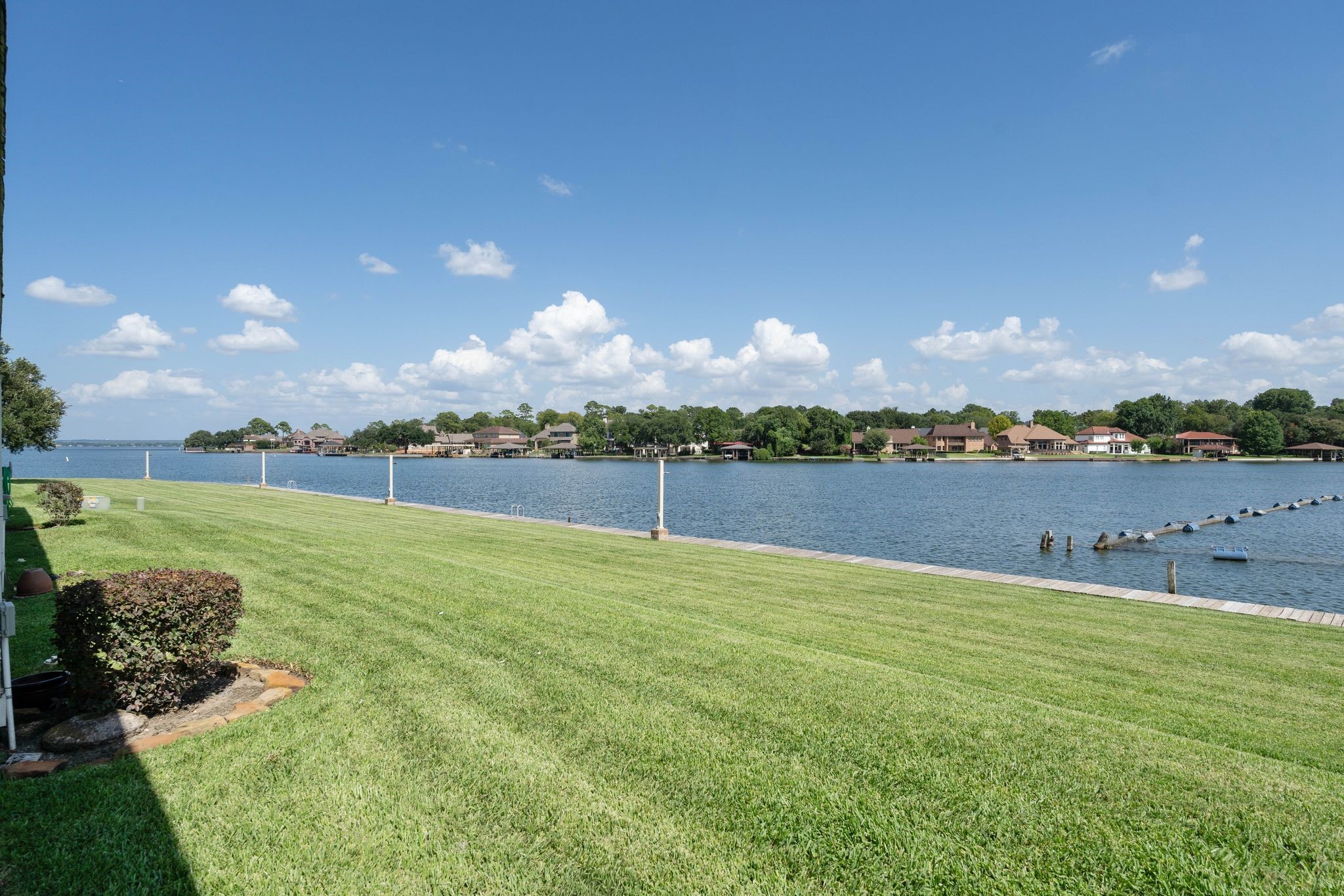 68 April Point Drive South, Unit E68 Conroe, TX 77356 - Photo 34 of 46 a view of a lake with houses in the background