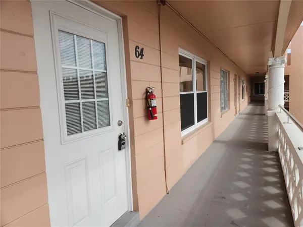 a view of a balcony with wooden floor and windows