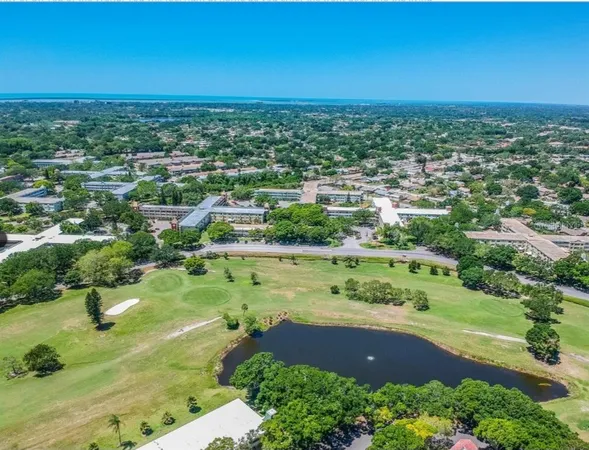an aerial view of residential houses with outdoor space and street view