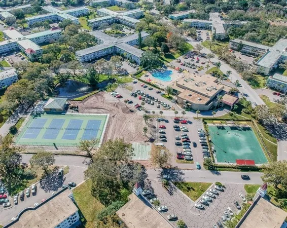 an aerial view of residential houses with outdoor space