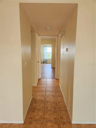 a view of a hallway with a glass door and painted walls
