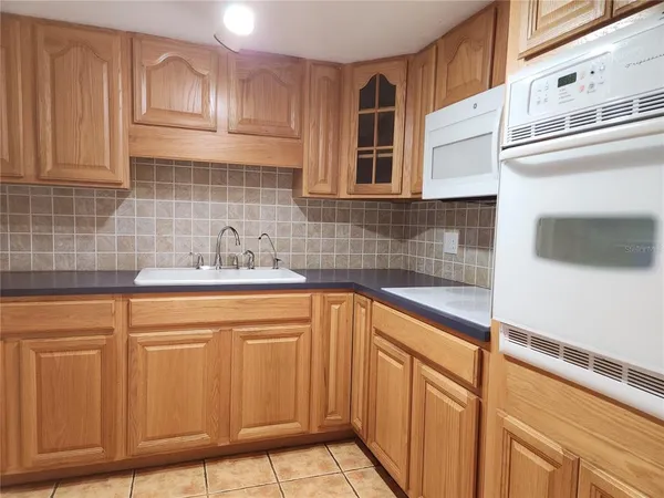 a kitchen with stainless steel appliances granite countertop a sink and cabinets