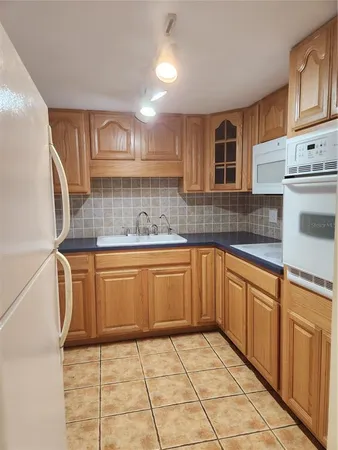 a kitchen with stainless steel appliances granite countertop a sink and cabinets