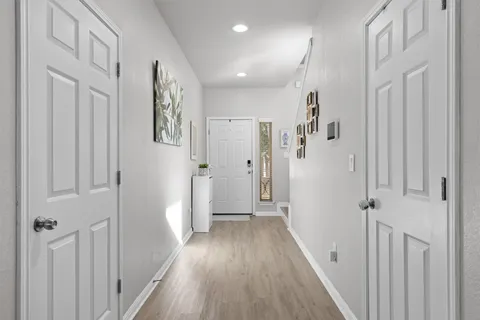 a bedroom with a bed and painting on the wall