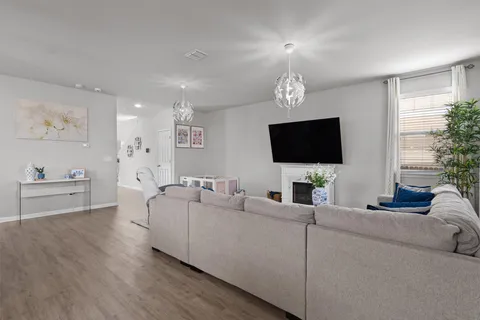 a view of a granite countertop kitchen island with a sink and a large mirror