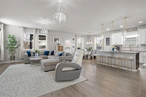a kitchen with granite countertop a sink a window and cabinets