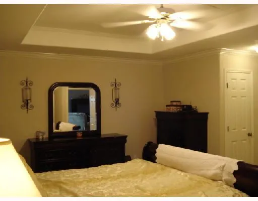 a bedroom with a bed and a mirror