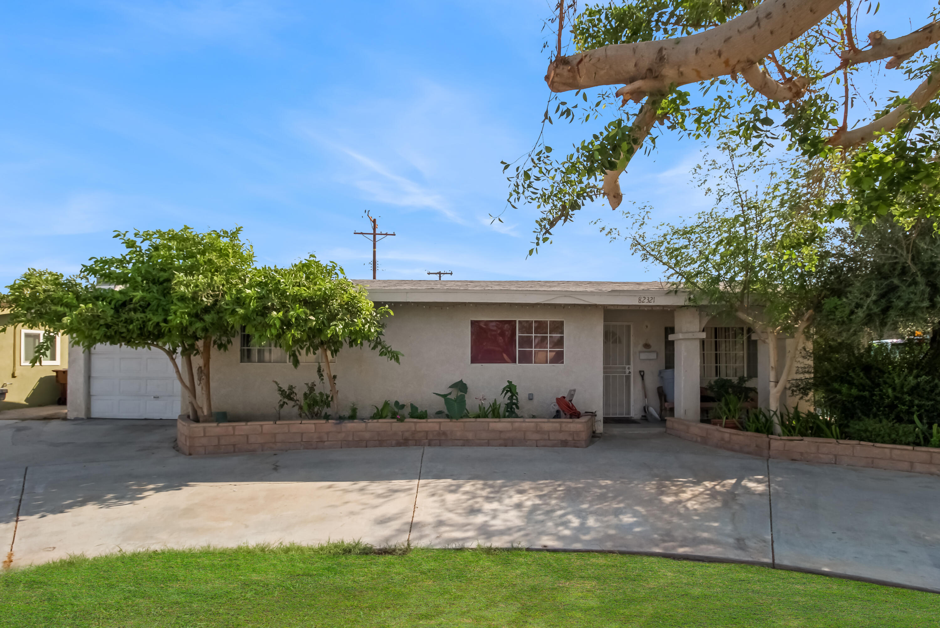 82321 Adobe Road Indio, CA 92201 - Photo 1 of 12 a front view of a house with garden