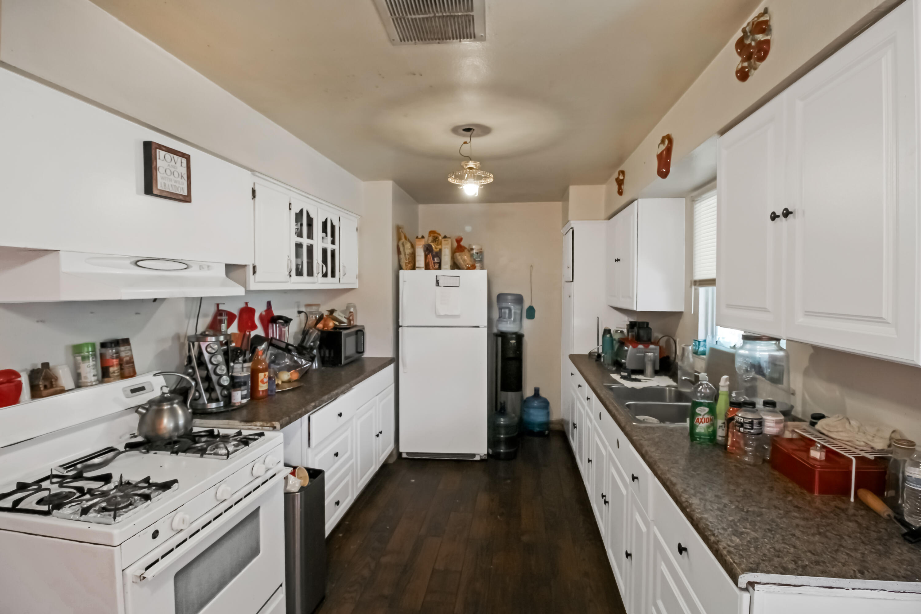 82321 Adobe Road Indio, CA 92201 - Photo 5 of 12 a kitchen with refrigerator a stove and cabinets