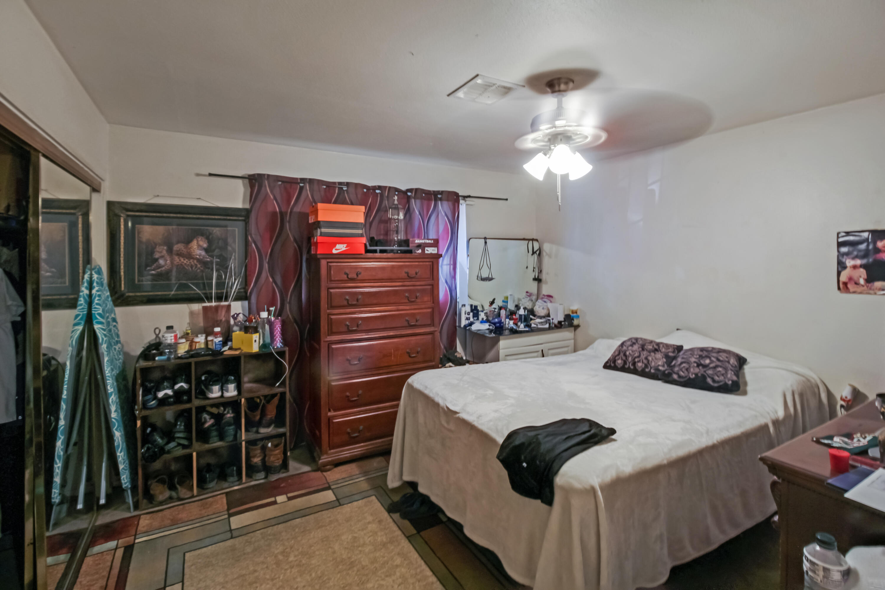 82321 Adobe Road Indio, CA 92201 - Photo 8 of 12 a bedroom with a bed and a chandelier