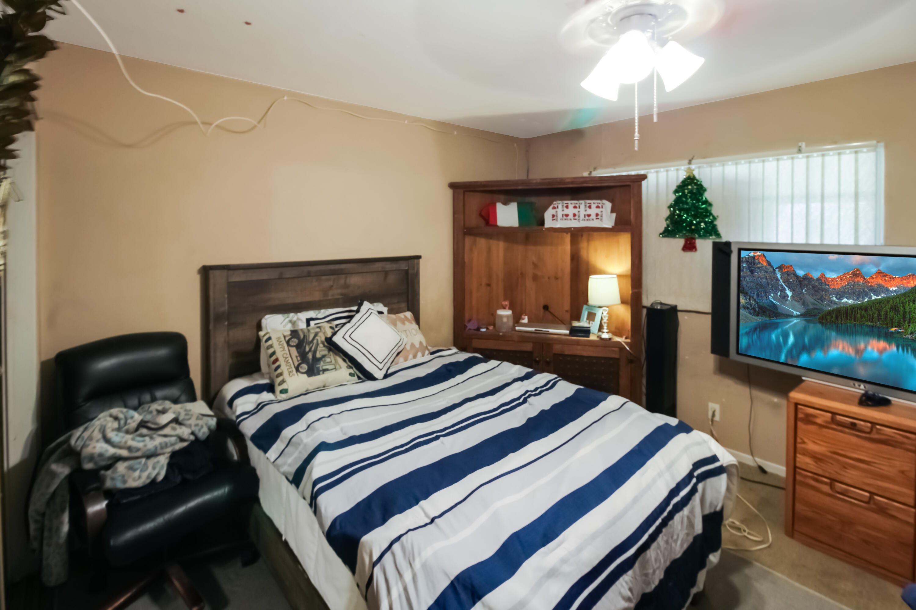 82321 Adobe Road Indio, CA 92201 - Photo 9 of 12 a bedroom with a bed and a flat screen tv