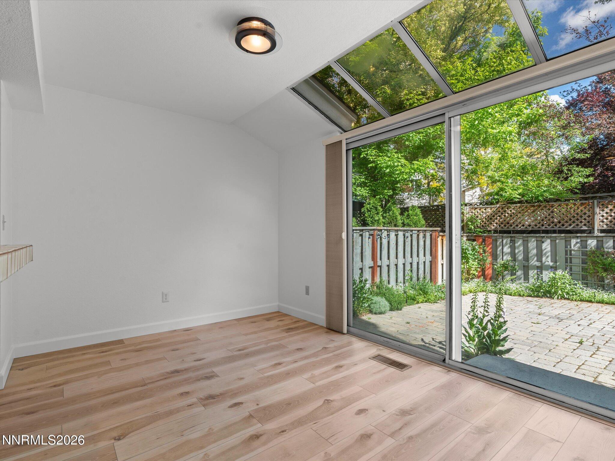 3170 Oakshire Court Reno, NV 89509 - Photo 16 of 43 a view of a room with wooden floor and iron fence