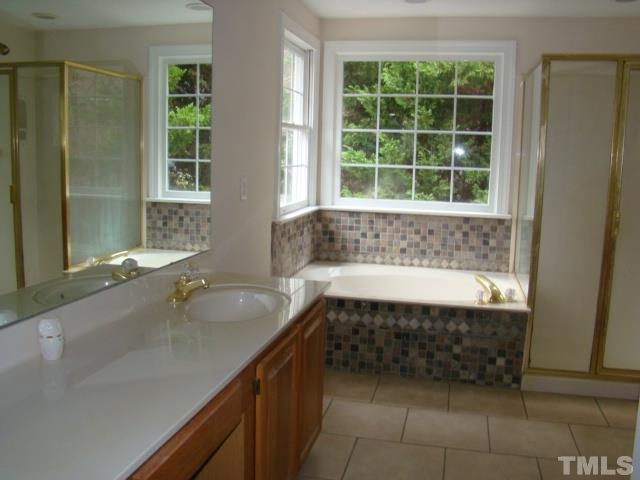 5504 Crossfield Drive Raleigh, NC 27613 - Photo 12 of 18 a bathroom with a bathtub and a sink
