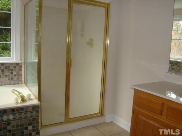 5504 Crossfield Drive Raleigh, NC 27613 - Photo 13 of 18 a bathroom with a granite countertop window and a sink
