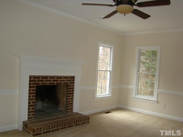 5504 Crossfield Drive Raleigh, NC 27613 - Photo 4 of 18 a living room with a fireplace and a window