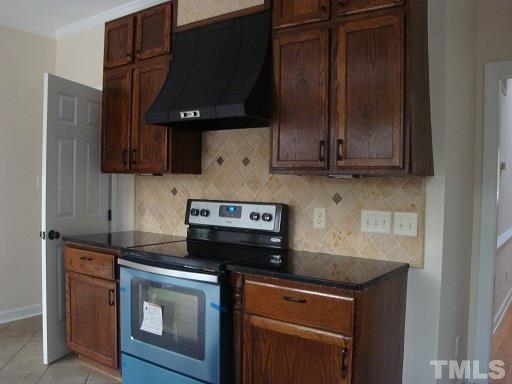 5504 Crossfield Drive Raleigh, NC 27613 - Photo 5 of 18 a kitchen with stainless steel appliances granite countertop a stove a microwave and a sink