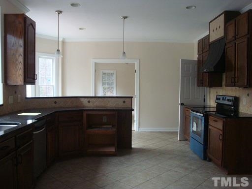 5504 Crossfield Drive Raleigh, NC 27613 - Photo 6 of 18 a kitchen with stainless steel appliances granite countertop a sink and a stove