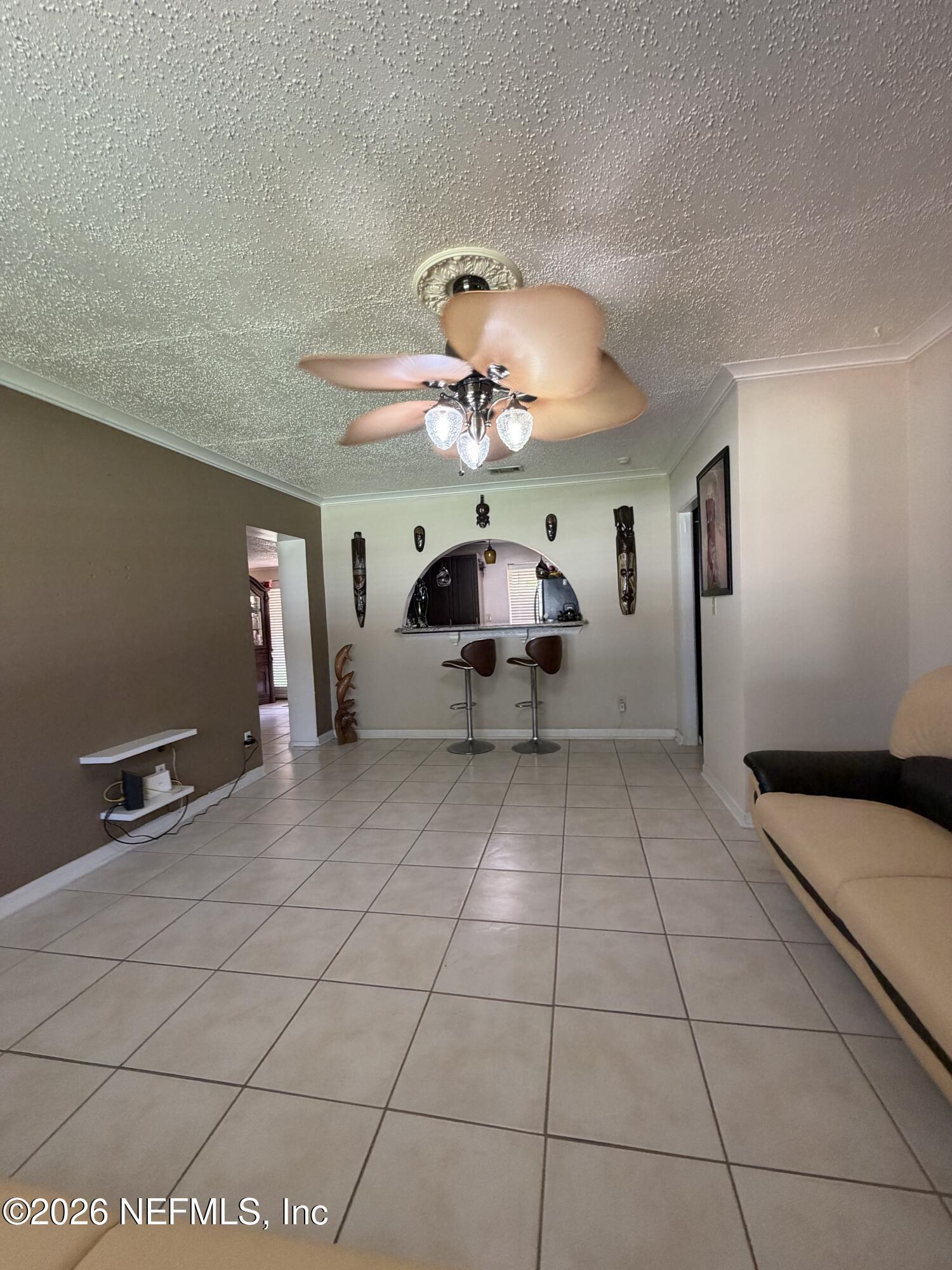 4127 Springwood Road Jacksonville, FL 32207 - Photo 8 of 63 a living room with furniture and a chandelier