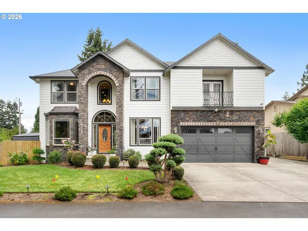 a front view of a house with a yard and garage