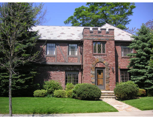 23 Sunset Road Newton, MA 02458 - Photo 1 of 1 a view of a stone house with a yard plants and large tree