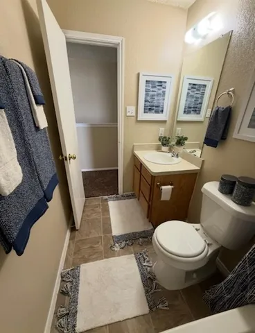 a bathroom with a toilet a sink and a mirror