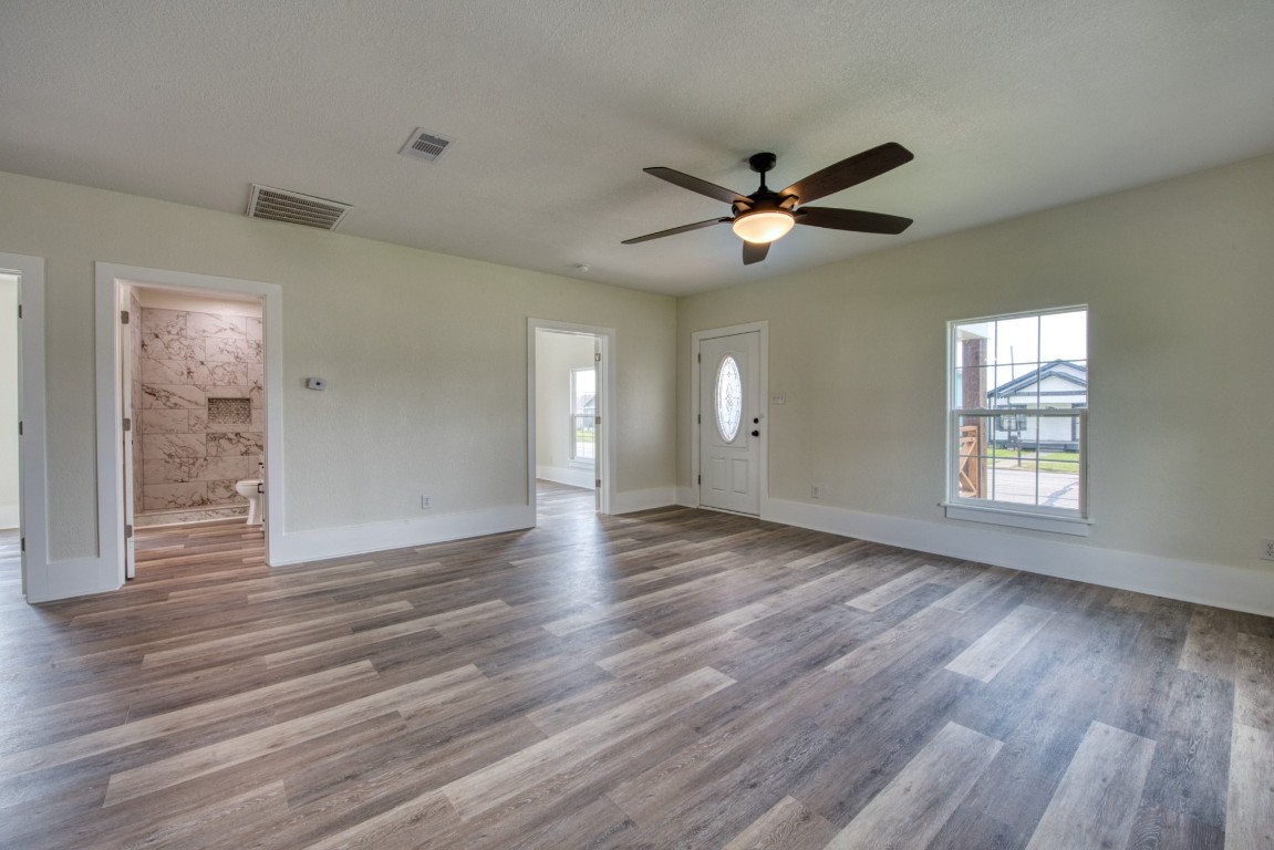 1122 West 2nd Street Freeport, TX 77541 - Photo 11 of 38 a view of empty room with wooden floor and fan