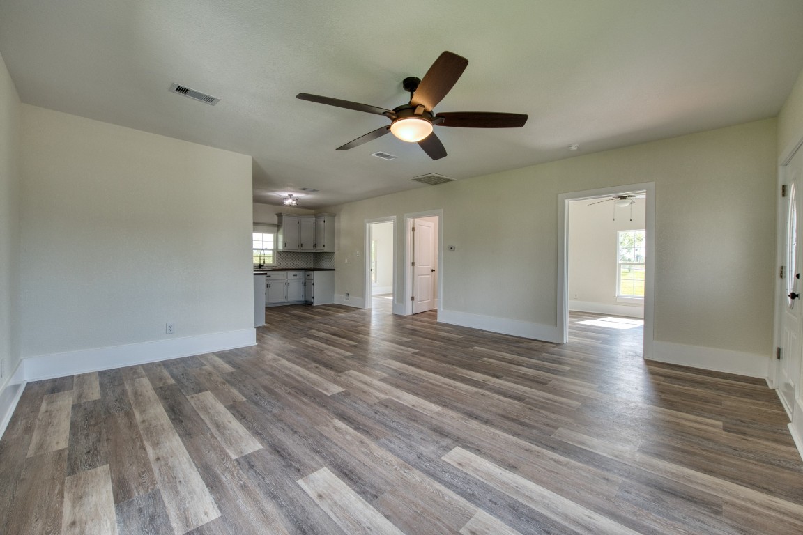 1122 West 2nd Street Freeport, TX 77541 - Photo 12 of 38 a view of empty room with wooden floor and windows