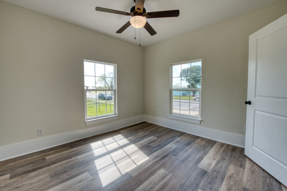 1122 West 2nd Street Freeport, TX 77541 - Photo 14 of 38 a view of empty room with wooden floor and fan