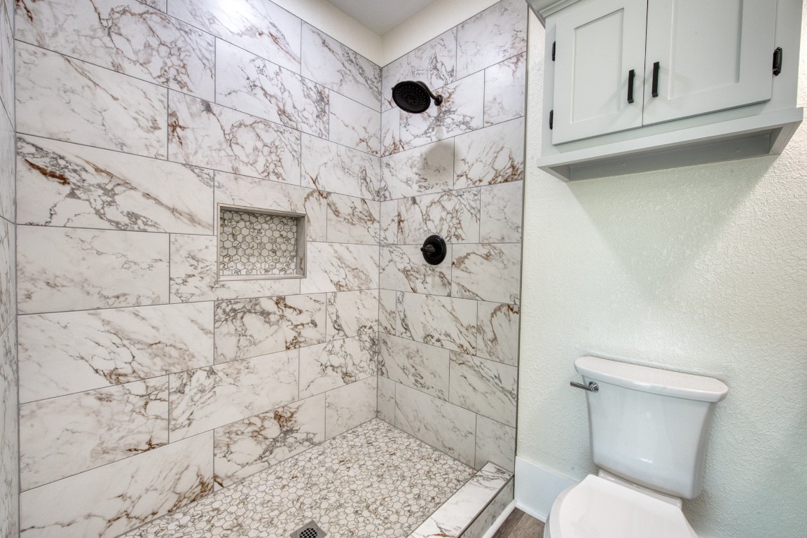 1122 West 2nd Street Freeport, TX 77541 - Photo 16 of 38 a bathroom with a toilet and a shower