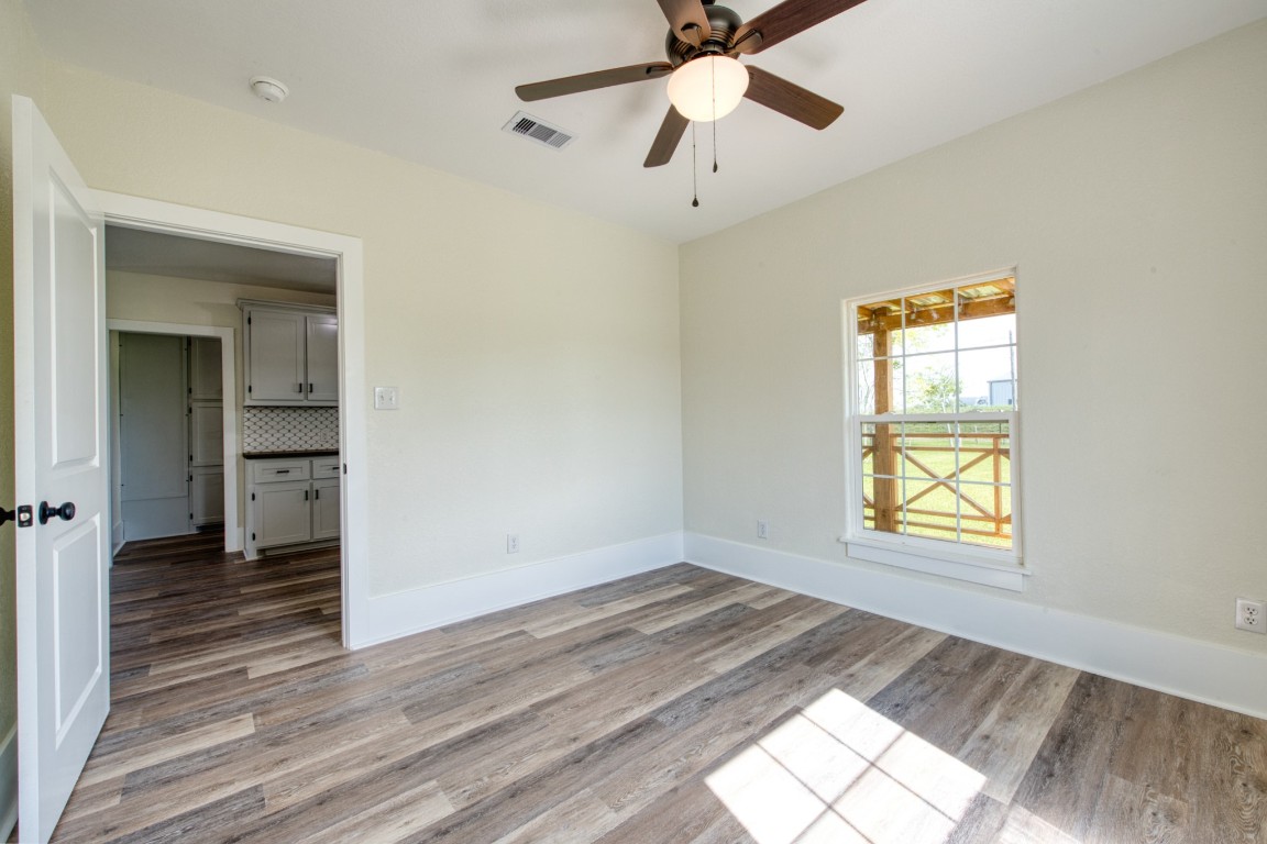 1122 West 2nd Street Freeport, TX 77541 - Photo 19 of 38 wooden floor in an empty room with a window