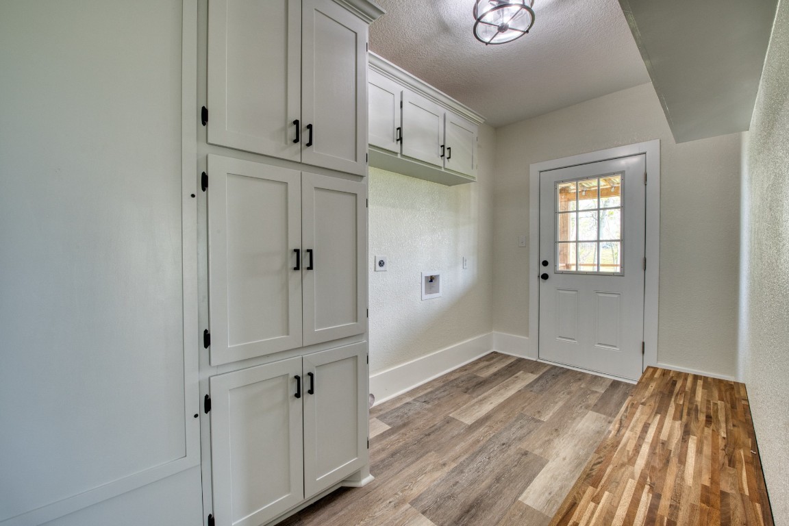 1122 West 2nd Street Freeport, TX 77541 - Photo 21 of 38 a view of an empty room with wooden floor and a window