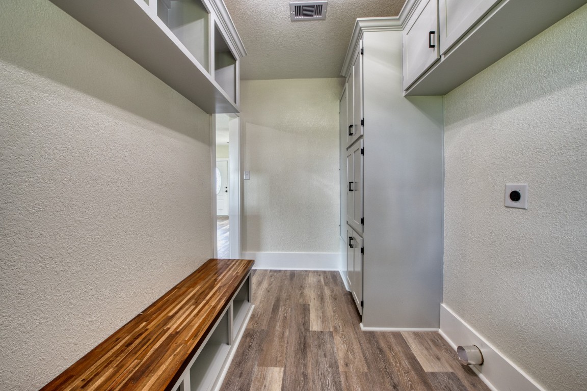 1122 West 2nd Street Freeport, TX 77541 - Photo 25 of 38 a view of a hallway with wooden floor and staircase