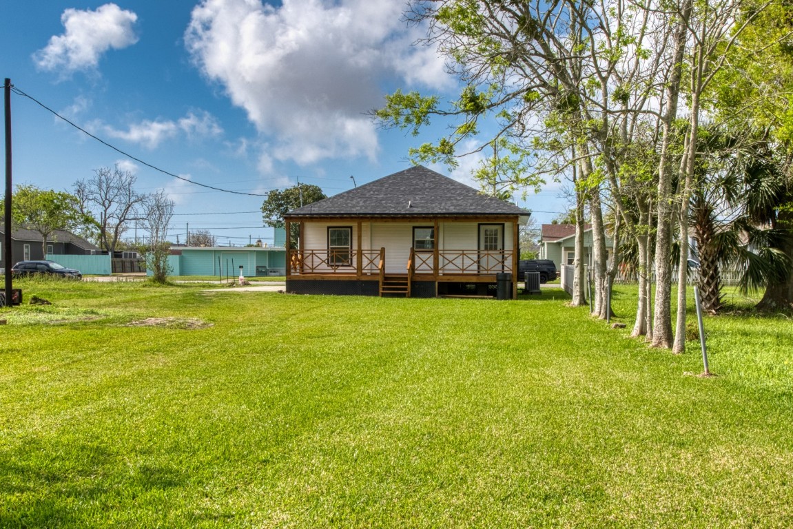 1122 West 2nd Street Freeport, TX 77541 - Photo 30 of 38 a front view of a house with a yard table and chairs