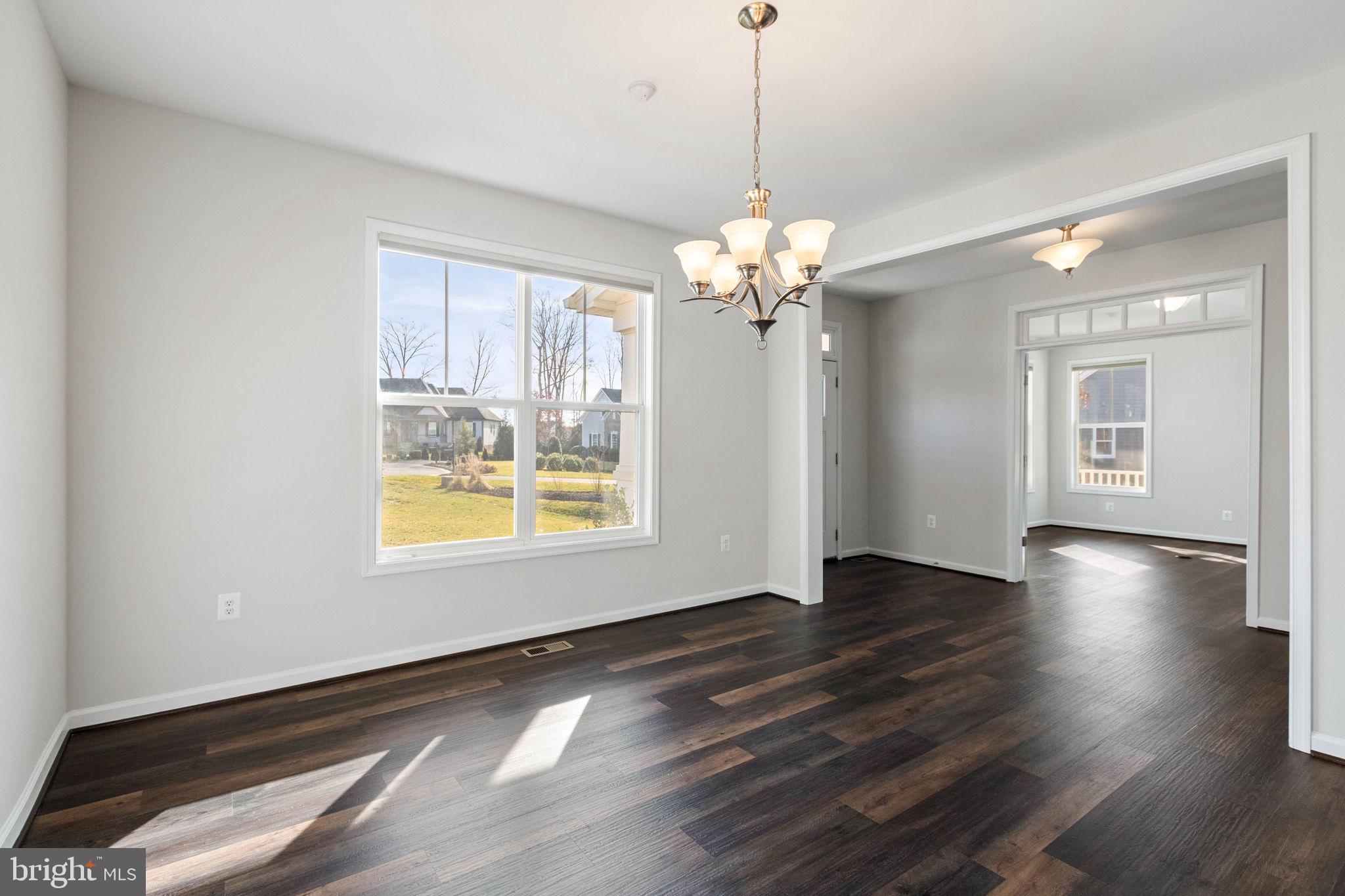 10602 Springvale Lane Spotsylvania, VA 22551 - Photo 11 of 92 a view of an empty room with wooden floor and a window