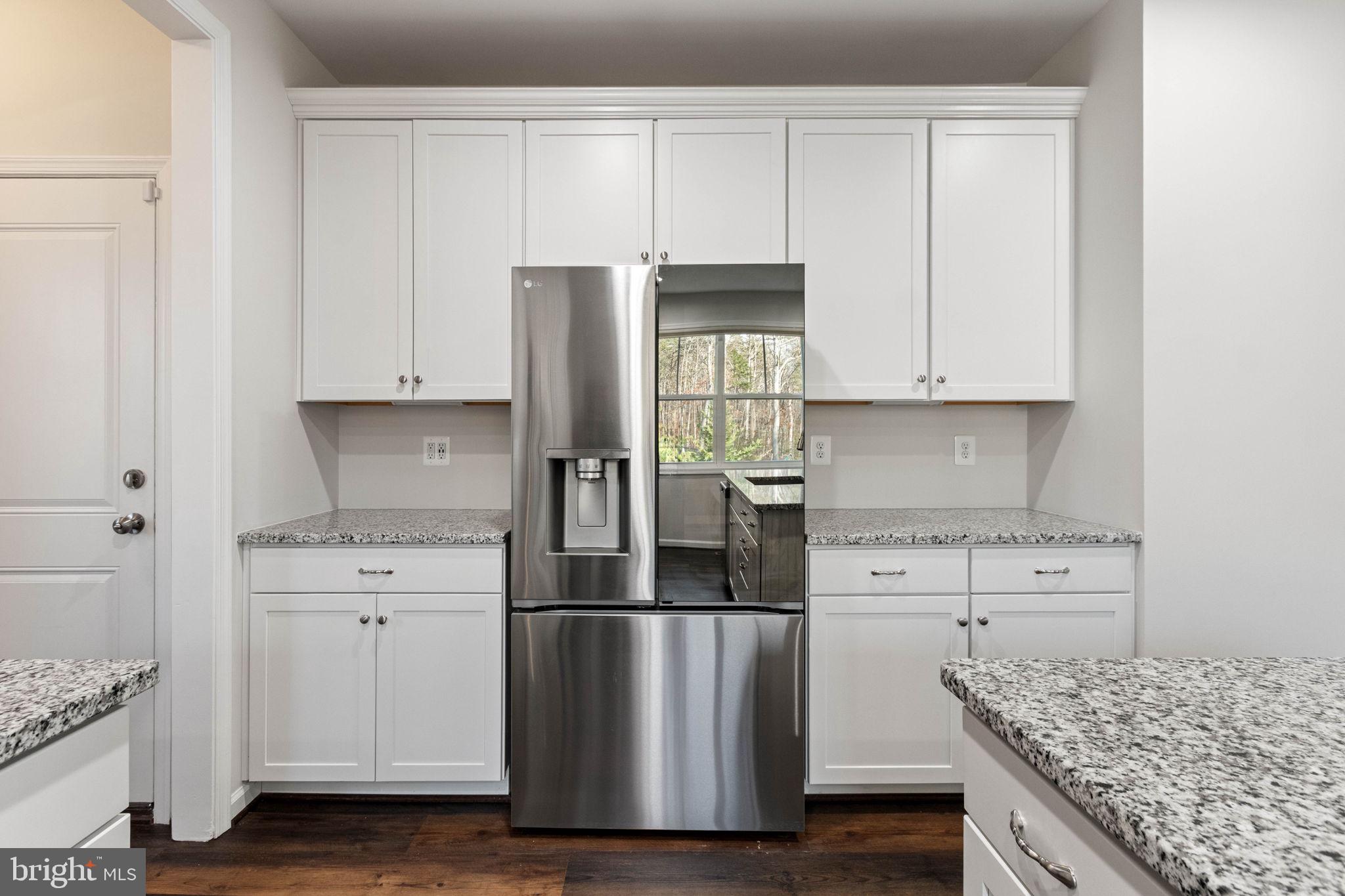 10602 Springvale Lane Spotsylvania, VA 22551 - Photo 18 of 92 a kitchen with stainless steel appliances granite countertop a stove a refrigerator and white cabinets