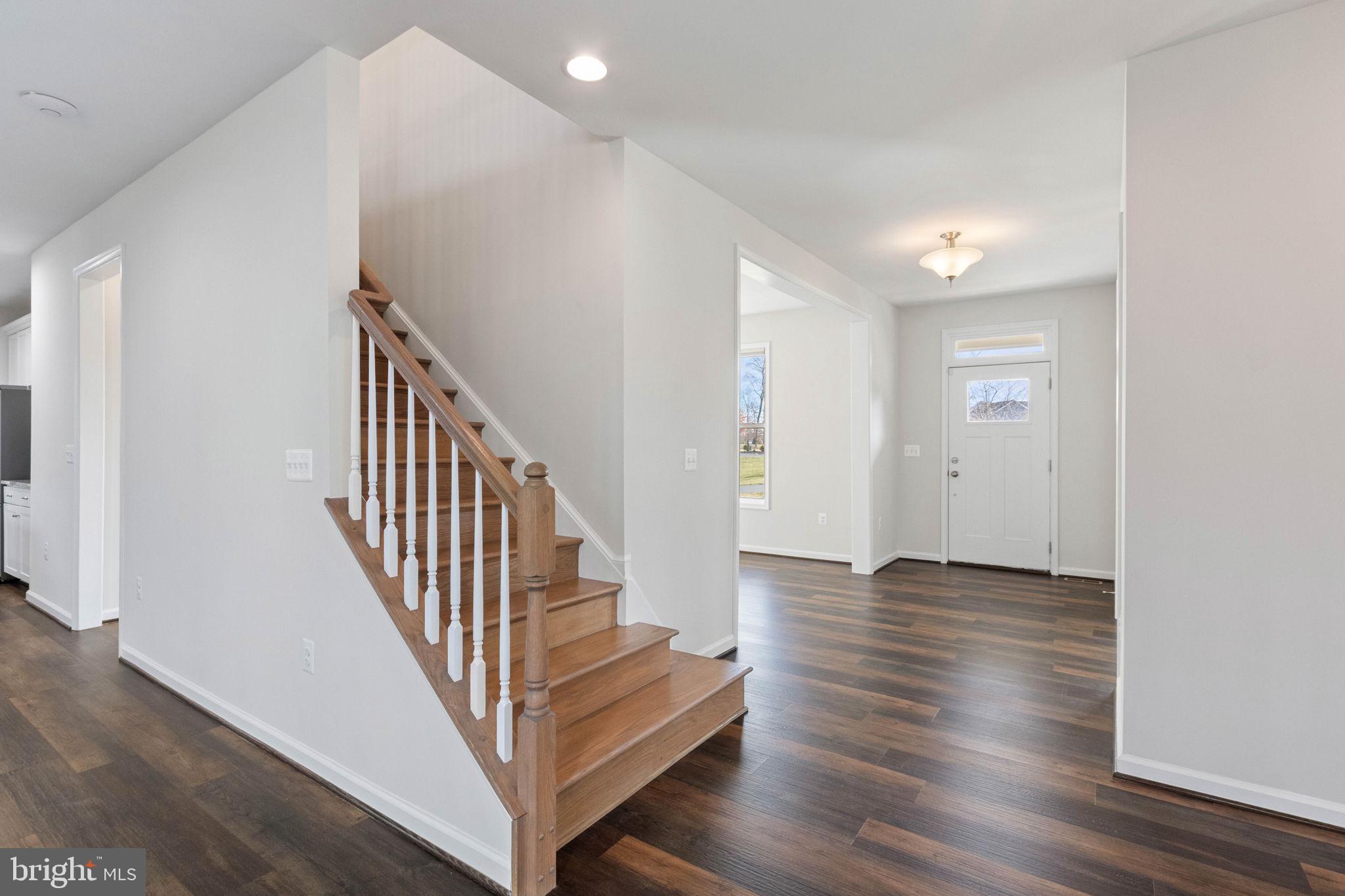 10602 Springvale Lane Spotsylvania, VA 22551 - Photo 25 of 92 a view of a hallway with wooden floor and staircase
